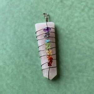 Arrow shaped seven chakra point pendant on rose quartz